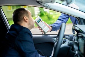 Breathalyzer test being administered to driver suspected of a DUI.